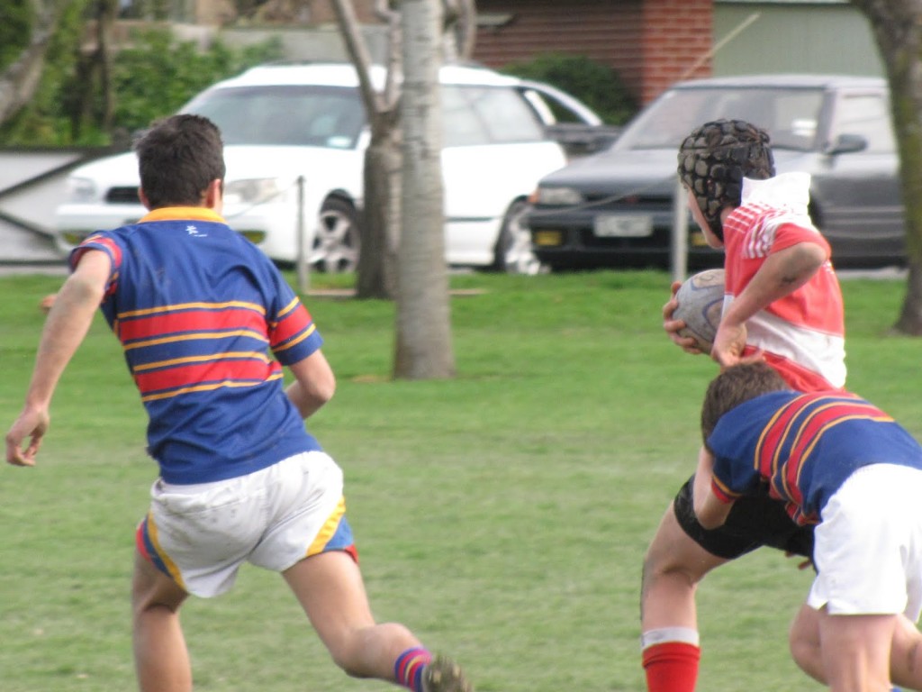 Luke charging down the field with ball in hand